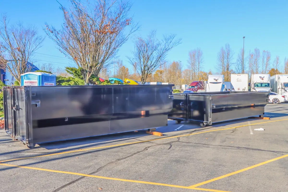 Professional dumpster rental service with roll-off container on residential driveway in Belpre